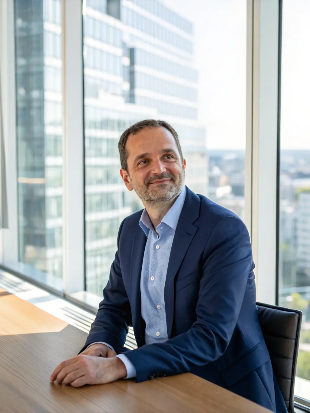 A professional headshot of the CEO of 2C2P, smiling confidently in a modern office setting, representing the company's leadership and innovation in financial technology.